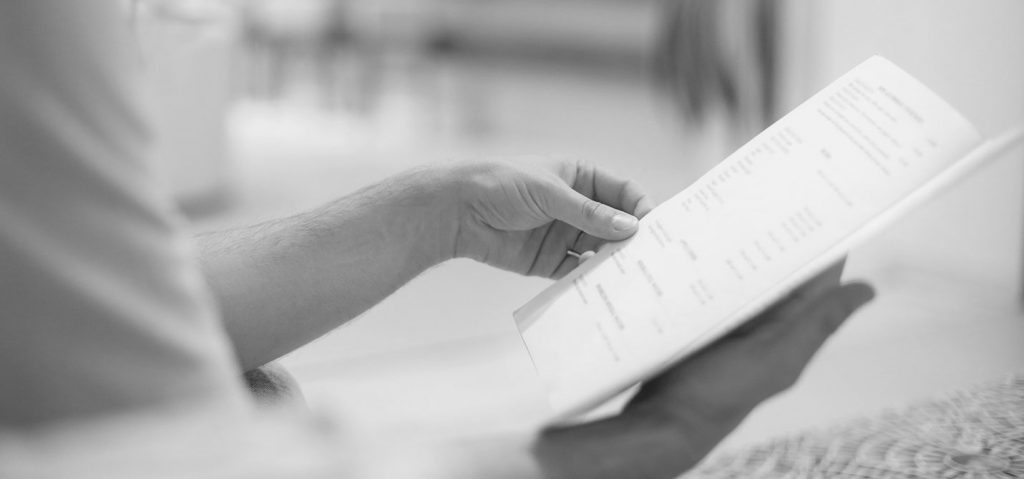 Person reading OHIP booklet for LASIK